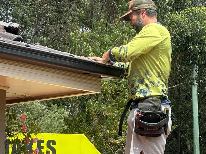 Jake installing gutter guard on a home